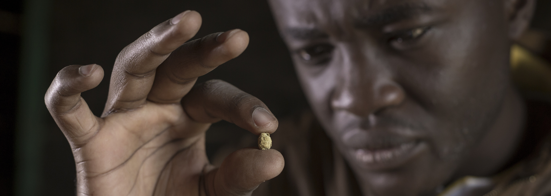 photo: Sven Torfinn. Democratic Republic of Congo DRC, Ituri Province, near Bunia, Mambasa. June 2017. Partnership Africa Canada’s (PAC) Just Gold project aims to bring legal, conflict-free and traceable gold from artisanal mine sites in the Democratic Republic of Congo to international markets. The pilot is fully operational in Ituri Province, from mine site in Mambasa Territory, to exporter in Bunia.Oscar at the mini-MAM in Unipe ni Kupe with Abdallah the mini-MAM negociant, during daily tasks of reviewing the log books and buying legal gold.